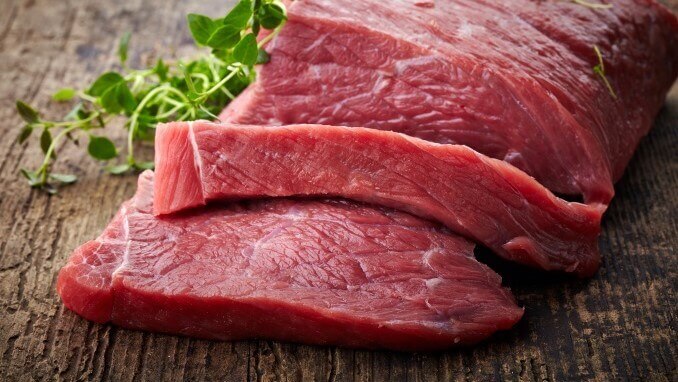 red raw meat on old wooden table