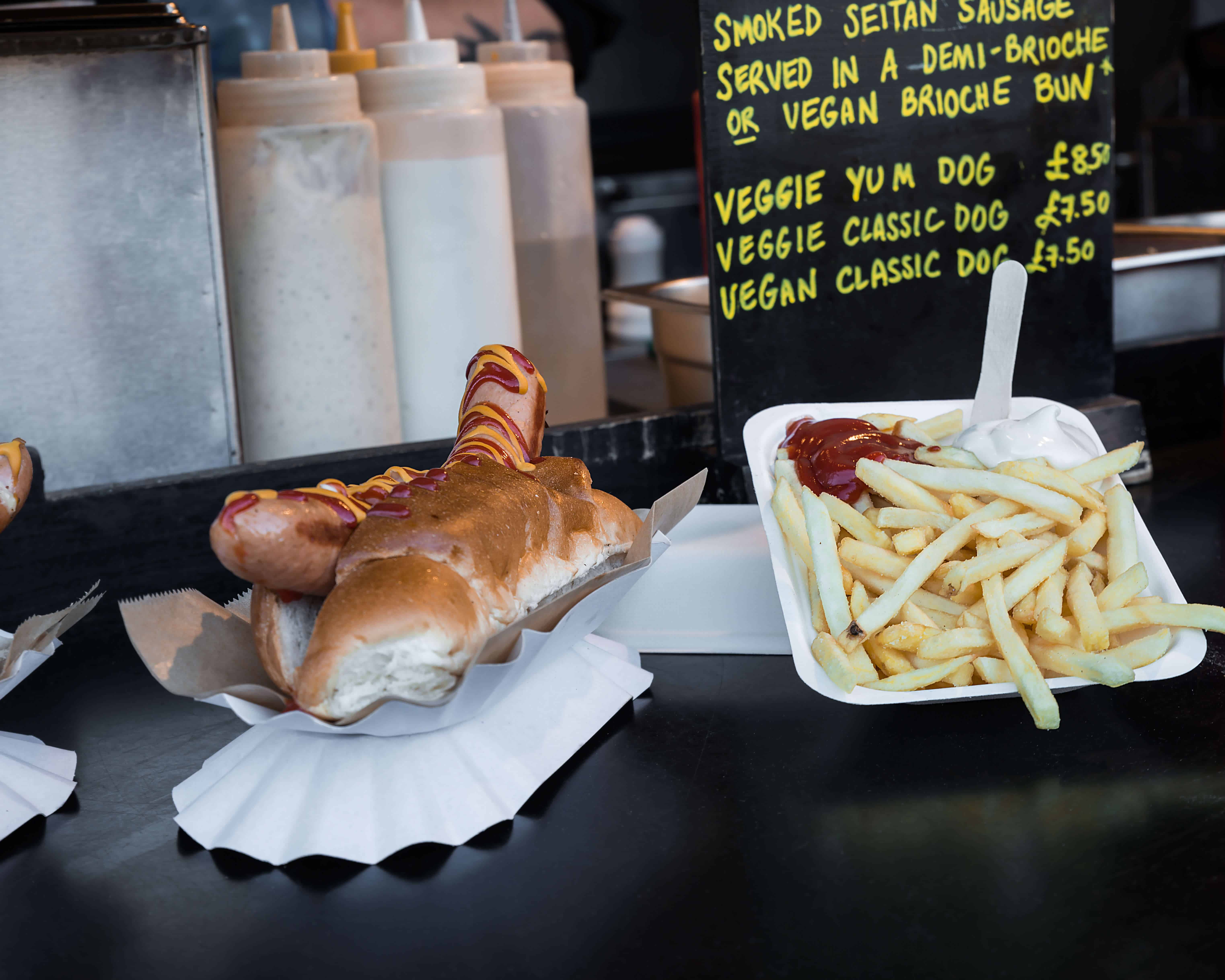 Vegan hot dog and french fries in Camden Town Market stand, London
