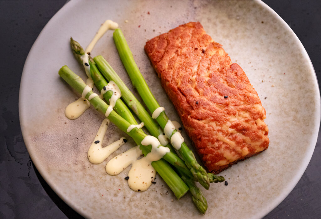 Revo Foods salmon filet on plate with asparagus