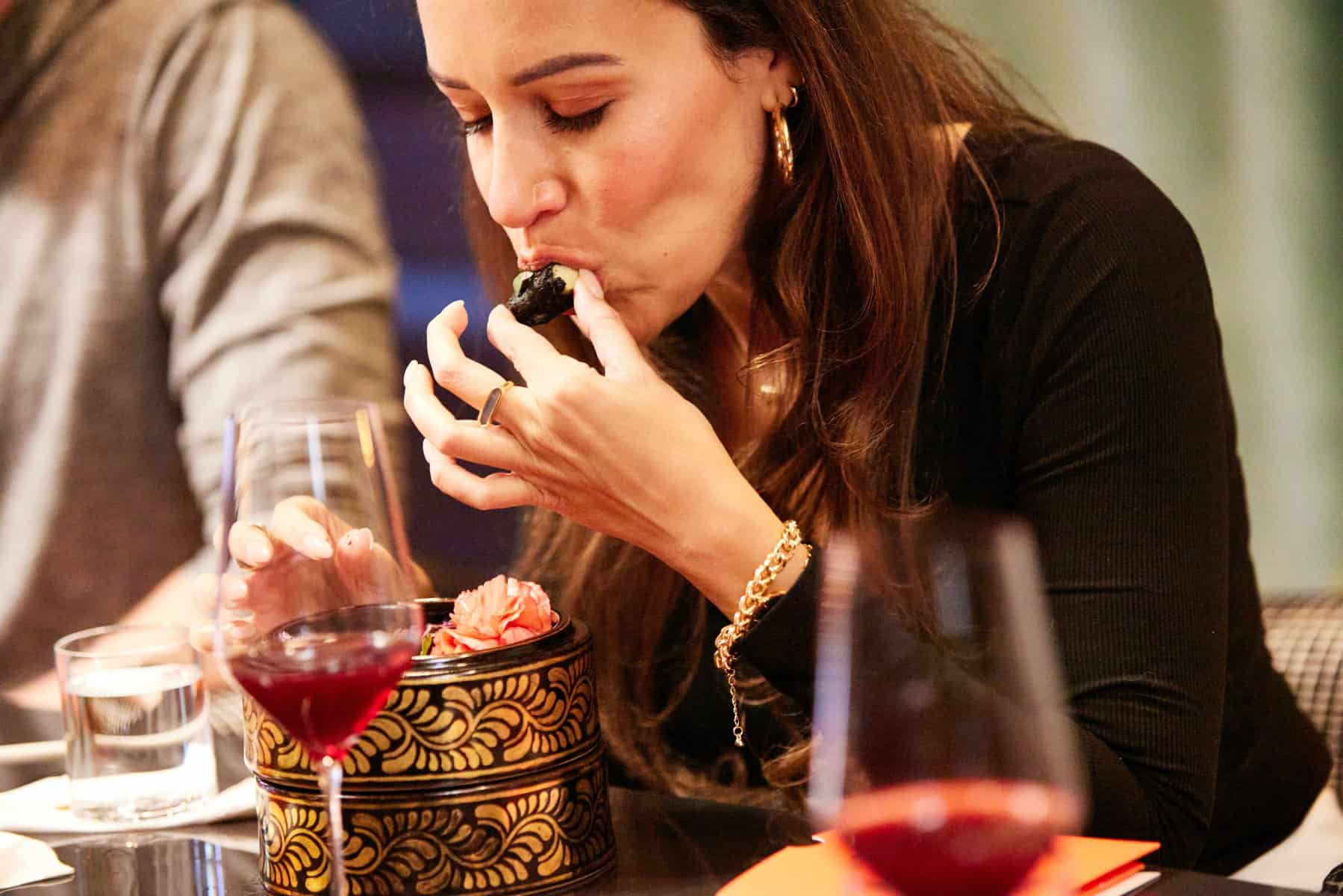 Guest trying cultivated chicken at Bar Crenn