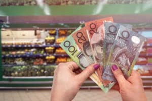 Australia fresh fruits and vegetables, hand with dollars